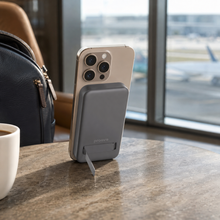 Proove OverPower Qi2 power bank behind phone in airport lounge